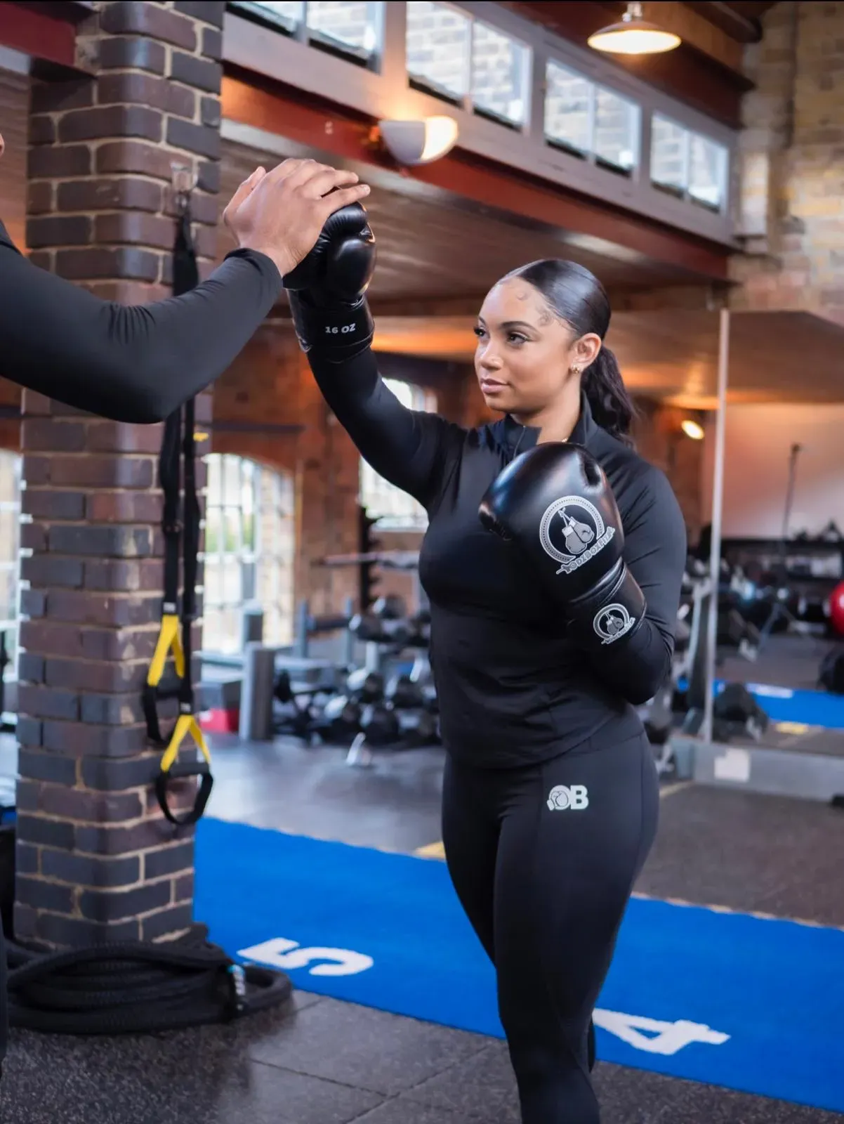 ODZBOXFIT coach working 1-on-1 on boxing technique with a client